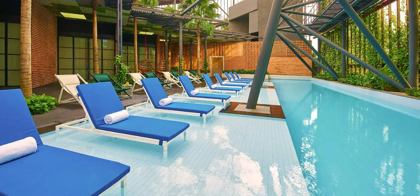 open-air infinity pool area view of Oasia Hotel Downtown Singapore, Bali